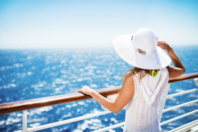 Lady on cruise ship deck looking out at the water